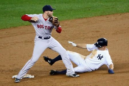 Oct 1, 2015; Bronx, NY, USA; Boston Red Sox second baseman Josh Rutledge (30) has New York Yankees left fielder Brett Gardner (11) out as attempts to complete the double play during the fifth inning at Yankee Stadium. Anthony Gruppuso-USA TODAY Sports