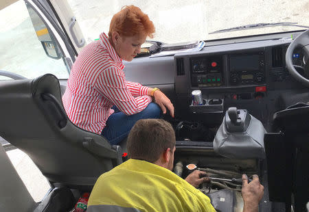 Australian senator Pauline Hanson watches a mechanic attempt to fix the bus she is travelling on after it broke down on the outskirts of the northern Australian town of Marlborough in Queensland, Australia, November 9, 2017. Picture taken November 9, 2017. REUTERS/Jonathan Barrett