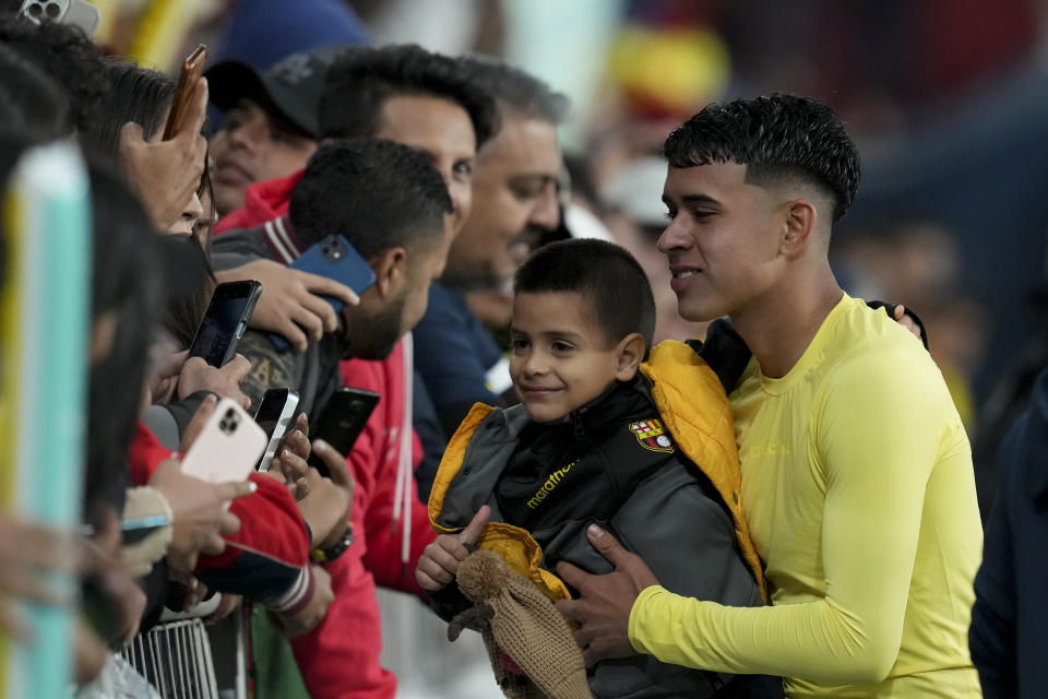 Ecuador's Kendry Paez, right, greets fans at the end of a qualifying soccer match against Chile for the FIFA World Cup 2026 at Rodrigo Paz Delgado Stadium in Quito, Ecuador, Tuesday, Nov. 21, 2023. (AP Photo/Dolores Ochoa)