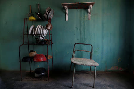 FILE PHOTO: A chair stands next to kitchen equipment in the house of Aidalis Guanipa, 25, a kidney disease patient, during a blackout in La Concepcion, Venezuela, April 12, 2019. REUTERS/Ueslei Marcelino