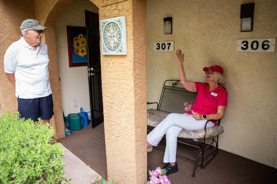 Lida Mainieri talks to her husband John Mainieri on the porch of their apartment in Tempe on July 28, 2022.