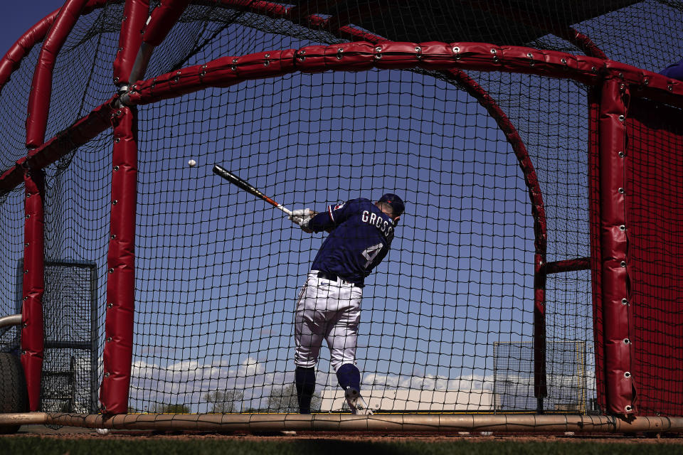 Texas Rangers' Robbie Grossman bats during spring training baseball practice Monday, Feb. 20, 2023, in Surprise, Ariz. (AP Photo/Charlie Riedel)