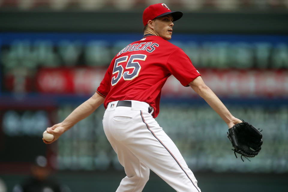 FILE - In this June 27, 2019, file photo, Minnesota Twins relief pitcher Taylor Rogers throws against the Tampa Bay Rays in a baseball game in Minneapolis. Major League Baseball will start each extra inning this season by putting a runner on second base. “I think you’ve all seen, with a runner on second base these days, we have to be pretty complicated with our sequences,” Rogers said. “I don’t see that speeding up the game. In fact, I see that slowing it down."(AP Photo/Jim Mone, File)