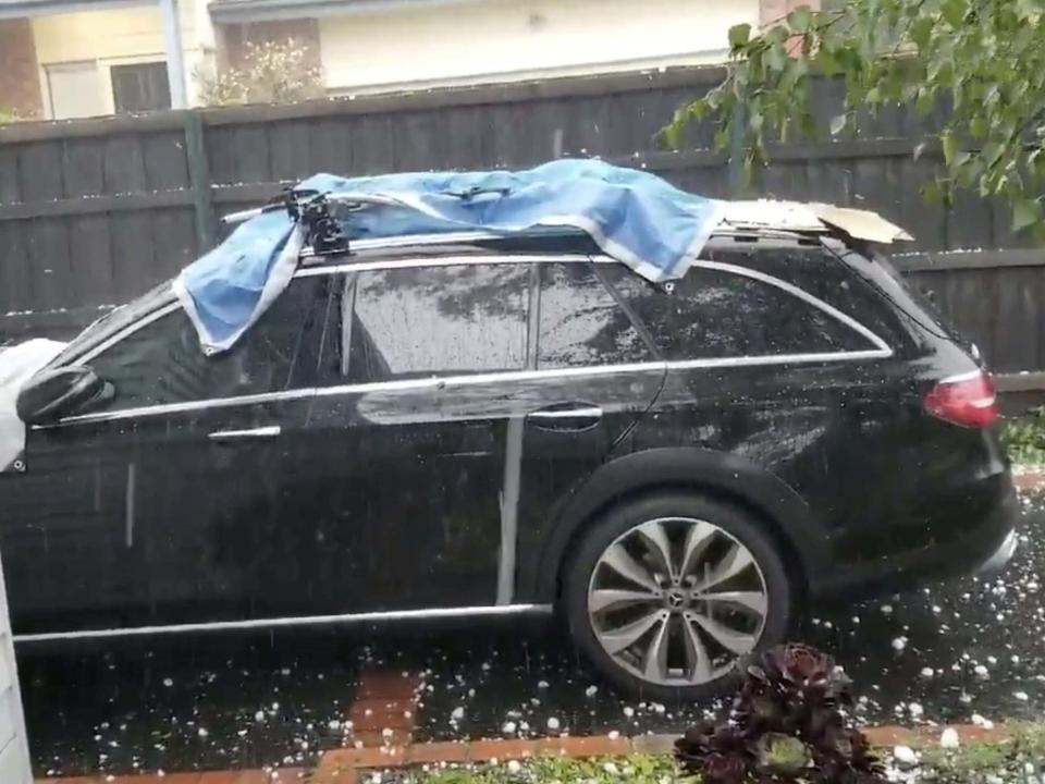 Hail stones fall on a car in Ashburton, Victoria: TWITTER @PETESHAKES via REUTERS