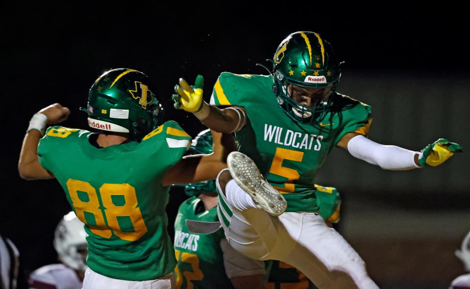 Idalou's Malakhi Brisco (5) celebrates with Gage Pounds (88) after scoring a touchdown during the game against Littlefield, Friday, Sept. 17, 2021, in Idalou, Texas.