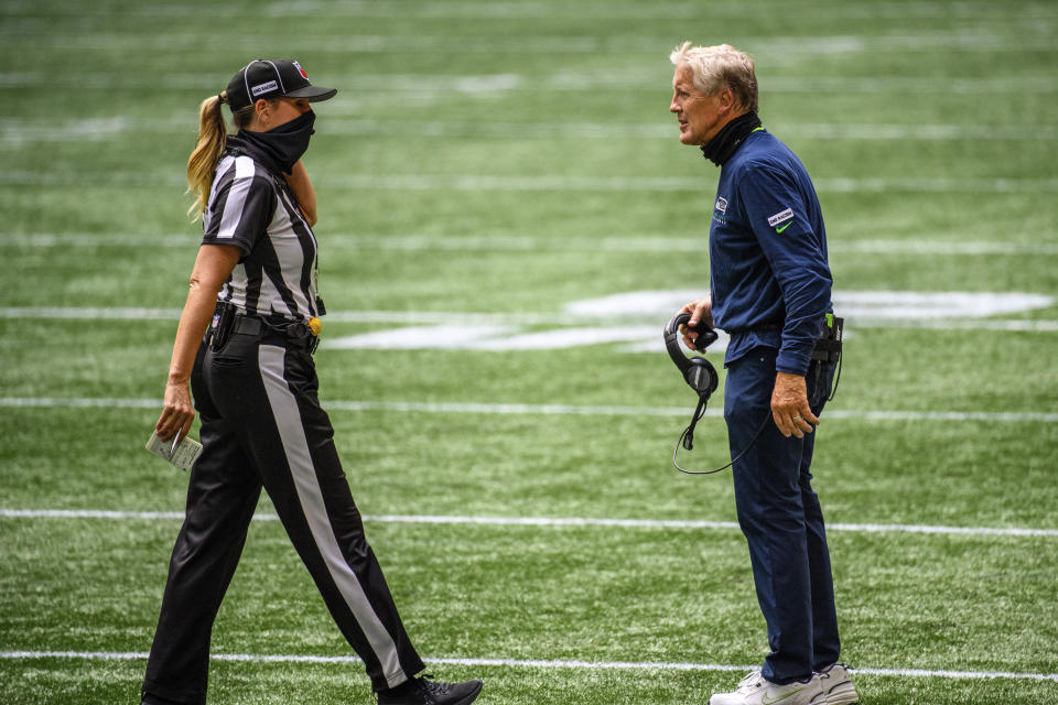 FILE - In this Sept. 13, 2020, file photo, Seattle Seahawks coach Pete Carroll talks with line judge Sarah Thomas during the first half of the team's NFL football game against the Atlanta Falcons in Atlanta. For the first time in NFL history, there will be two female coaches on the sideline and a female official on the field when the Browns host the Washington Football team. Jennifer King is in her first season on Washington’s staff while Callie Brownson is the chief of staff for Browns first-year coach Kevin Stefanski. Thomas became the league’s first female official in 2015, has worked in the postseason and is now making more history. (AP Photo/Danny Karnik, File)