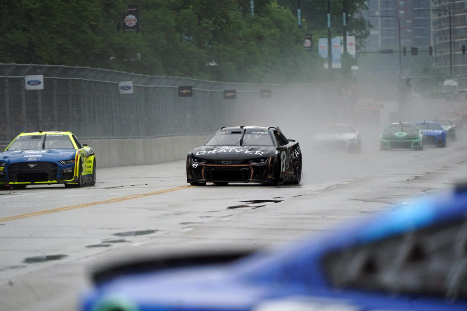 Erik Jones, center and other drivers compete in a NASCAR Cup Series auto race at the Grant Park 220, Sunday, July 2, 2023, in Chicago. (AP Photo/Erin Hooley)