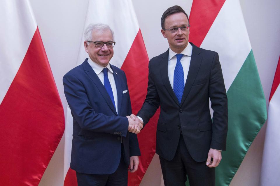 Hungarian Minister of Foreign Affairs and Trade Peter Szijjarto, right, receives Polish Minister of Foreign Affairs Jacek Czaputowicz at the Minister of Foreign Affairs and Trade in Budapest, Hungary, Wednesday, Feb. 27, 2019. (Zoltan Balogh/MTi via AP)