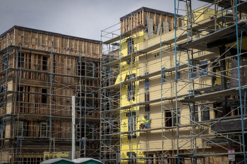 IRVINE, CALIF. -- MONDAY, JANUARY 28, 2019: Construction workers work on Central Park West homes and apartments in Irvine, Calif., on Jan. 28, 2019. California construction workers, builders are near deal that could mean a flood of new building. Major housing developers in California and the state's construction workers union are nearing a deal on wage and environmental issues to spur new homebuilding. (Allen J. Schaben / Los Angeles Times)