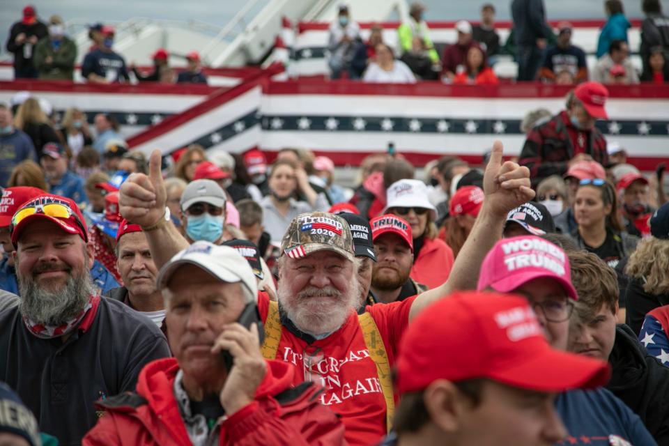 Raymond Badour, 65, of Grove City flashes two thumbs up before President Donald Trump delivers remarks at an airport hanger in Freeland Michigan Thursday, Sept. 10, 2020.