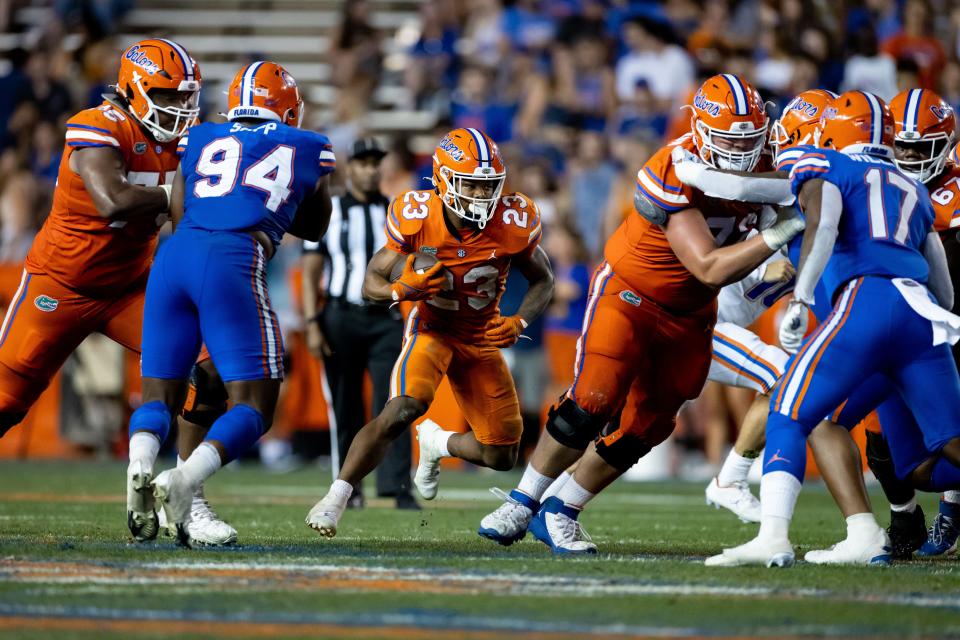 Florida Gators running back Demarkcus Bowman (23) runs with the ball during the second half during the Orange and Blue Spring Game at Steve Spurrier Field at Ben Hill Griffin Stadium in Gainesville, FL on Thursday, April 14, 2022. [Matt Pendleton/Gainesville Sun]