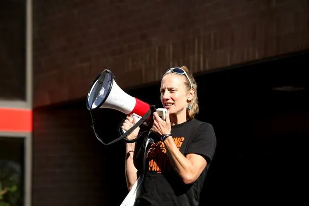 Sue Altman, in her megaphone days, leads a protest outside Rep. Josh Gottheimer's district office in August 2021. Republicans have dubbed her 