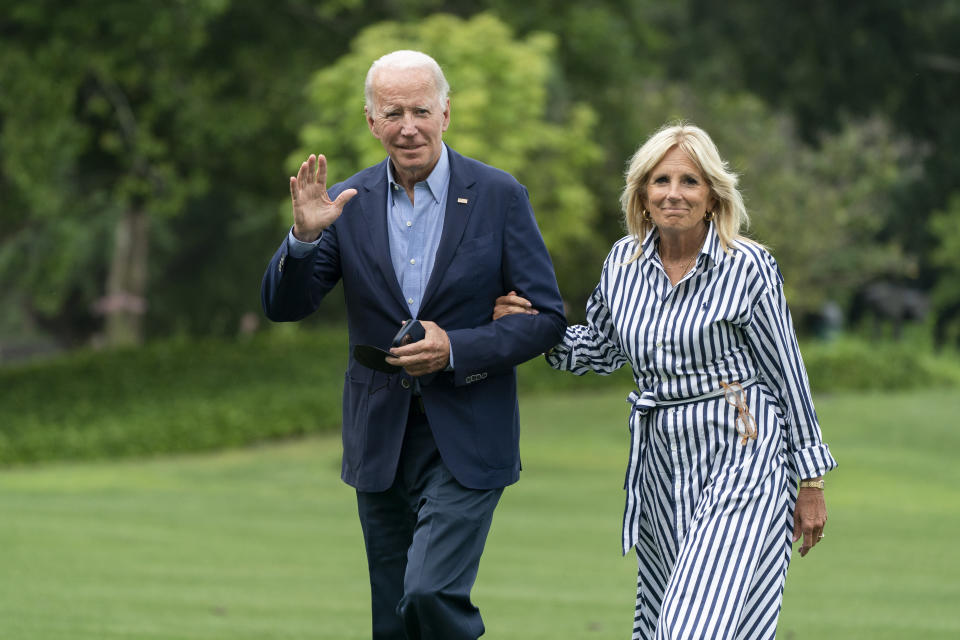 President Joe Biden with first lady Jill Biden waves as they walk on the South Lawn of the White House in Washington, upon arrival from a trip to visit flood affected areas in Kentucky, Monday, Aug. 8, 2022. (AP Photo/Manuel Balce Ceneta)