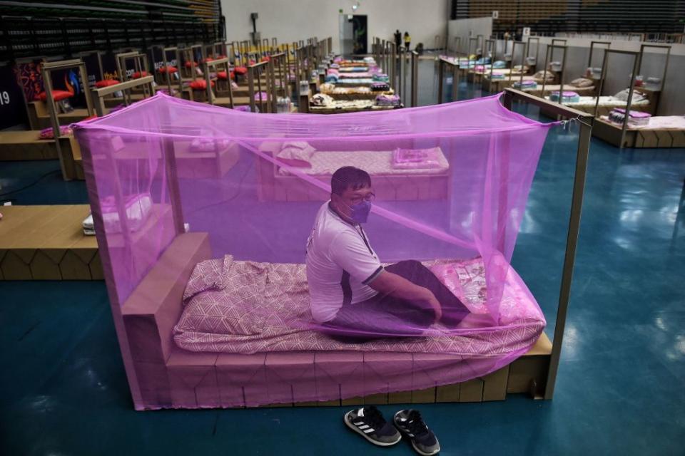 A Bangkok Metropolitan Administration worker tests a bed for incoming COVID-19 coronavirus patients at a new field hospital in a sports stadium on the outskirts of Bangkok on April 18, 2021.<span class="copyright">Lillian Suwarnumpha—AFP/Getty Images</span>