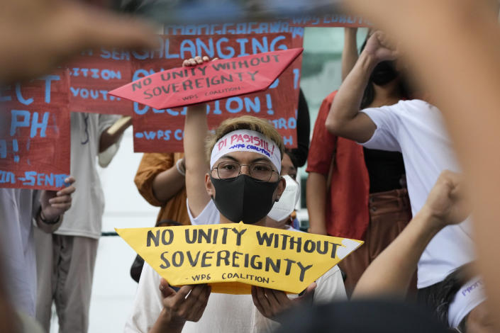 Protesters hold slogans to mark the 6th anniversary of the issuance of the 2016 decision by an arbitration tribunal set up under the U.N. Convention of the Law of the Sea after the Philippines complained against China's increasingly aggressive actions in the disputed sea during a rally outside the Chinese consulate in Makati, Philippines, Tuesday, July 12, 2022. U.S. Secretary of State Antony Blinken renewed a call to China to comply with a 2016 arbitration ruling that invalidated Beijing's vast claims in the South China Sea and warned that Washington is obligated to defend treaty ally Philippines if its armed forces, public vessels or aircraft come under attack in the disputed waters. (AP Photo/Aaron Favila)