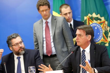 Brazil's President Jair Bolsonaro and Brazil's Environment Minister Ricardo Salles attend a news conference at the Planalto Palace in Brasilia