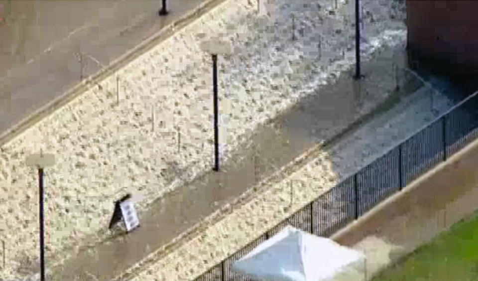 In this photo taken from video provided by nbc4la.com, water cascades into a parking structure adjacent to Pauley Pavilion, home of UCLA basketball, after a 30-inch water main burst on nearby Sunset Boulevard Tuesday, July 29, 2014, in Los Angeles. (AP Photo/nbc4la.com)