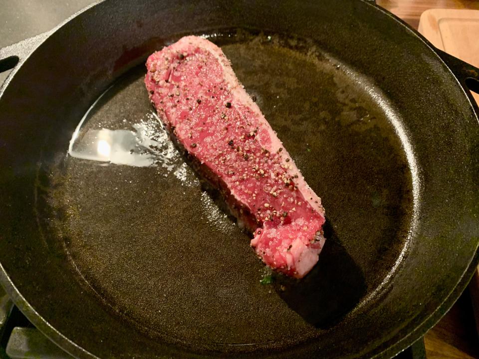 raw steak on pan