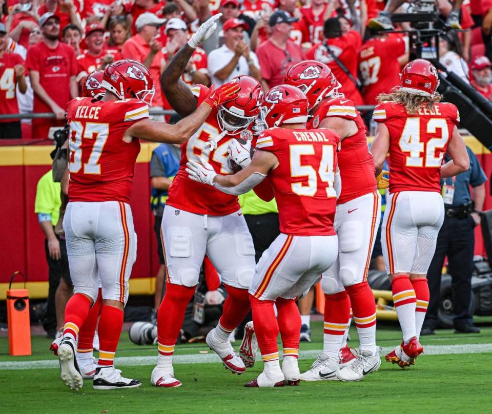 Teammates celebrate with Kansas City Chiefs offensive tackle Wanya Morris (64) after he caught a pass for a touchdown in the third quarter against the Cincinnati Bengals Sunday, Sept. 15, 2024, at GEHA Field at Arrowhead Stadium.