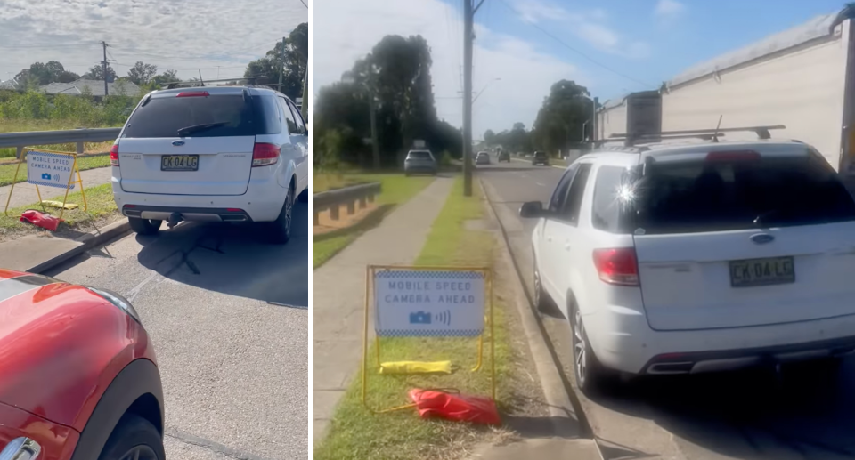 The mobile speed camera mounted to a grey vehicle can be seen in the distance as the warning sign, which reads 'mobile speed camera ahead' is seen next to parked cars on the highway.