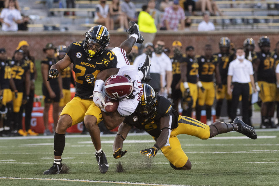 Alabama wide receiver Jaylen Waddle, center, is sandwiched between Missouri's Clark Griffin, left, and Tyree Gillespie, right, during the first quarter of an NCAA college football game Saturday, Sept. 26, 2020, in Columbia, Mo. (AP Photo/L.G. Patterson)