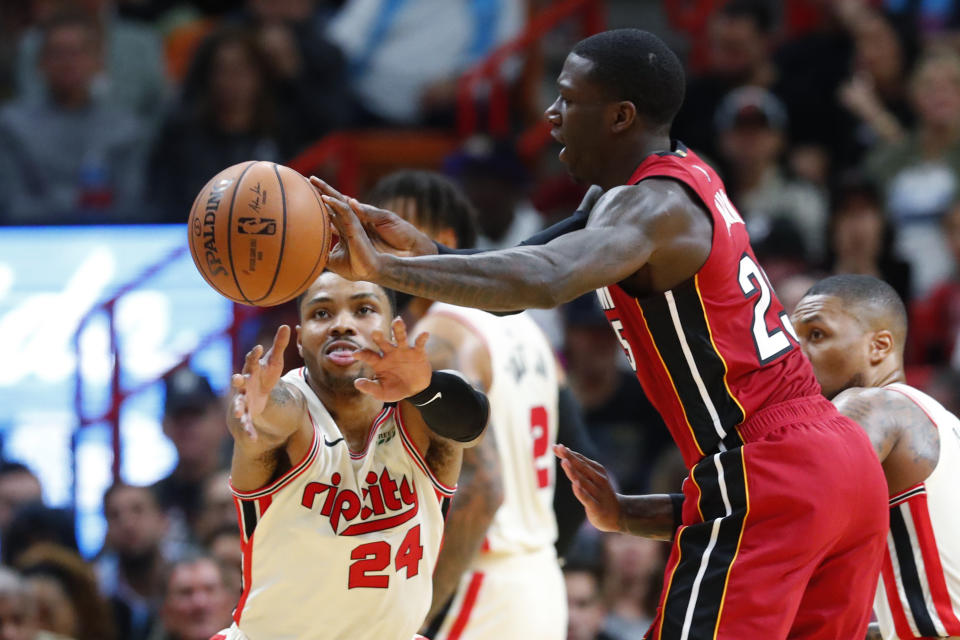 Miami Heat guard Kendrick Nunn (25) passes past Portland Trail Blazers guard Kent Bazemore (24) during the first half of an NBA basketball game, Sunday, Jan. 5, 2020, in Miami. (AP Photo/Wilfredo Lee)