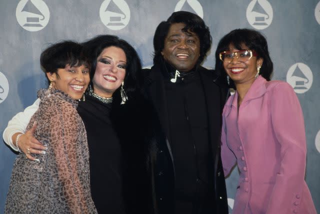 <p>Vinnie Zuffante/Getty</p> James Brown poses with Yamma Brown, Deanna Brown and Adrienne Rodriguez at the Radio City Music Hall in New York City in February 1992