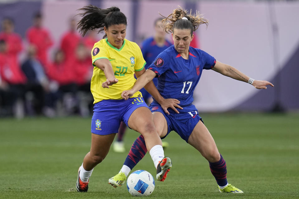 United States' Sam Coffey (17) battles Brazil's Duda (20) for the ball during the first half of the CONCACAF Gold Cup women's soccer tournament final match, Sunday, March 10, 2024, in San Diego. (AP Photo/Gregory Bull)