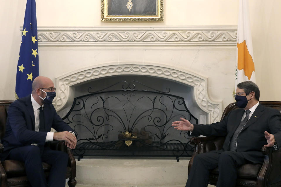 European Union Council President Charles Michel, left, and Cyprus President Nicos Anastasiades wear face masks to prevent the spread of COVID-19 talk during their meeting at the Presidential Palace in the capital Nicosia, Cyprus, on Wednesday, Sept.16, 2020. Michel is visiting Cyprus after traveling to Greece amid a diplomatic drive to de-escalate a weeks-long standoff at sea over Turkey's hydrocarbons search in waters were Greece and Cyprus claim exclusive economic rights. (Yiannis Kourtoglou, Pool via AP)