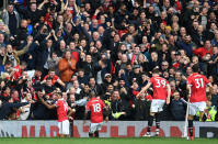 <p>United fans and players celebrate Marcus Rashford’s first goal </p>