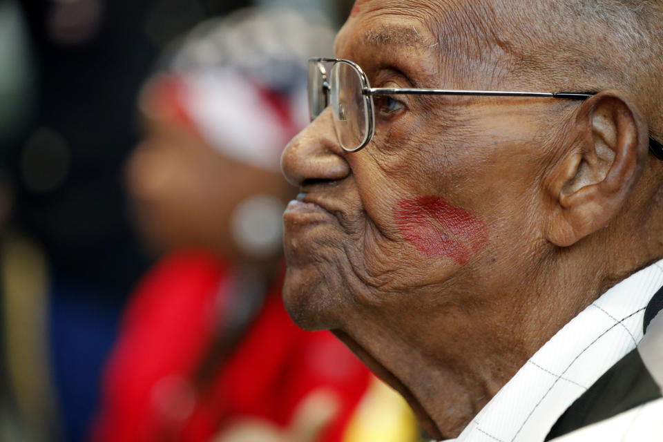 World War II veteran Lawrence Brooks sports a lipstick kiss on his cheek, planted by a member of the singing group Victory Belles, as he celebrates his 110th birthday at the National World War II Museum in New Orleans, Thursday, Sept. 12, 2019. Brooks was born Sept. 12, 1909, and served in the predominantly African-American 91st Engineer Battalion, which was stationed in New Guinea and then the Philippines during World War II. He was a servant to three white officers in his battalion. (AP Photo/Gerald Herbert)