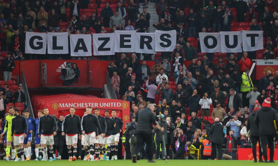 Manchester United fans hold banners in protest against their owners as the players take to the Old Trafford pitch for their match against Chelsea in April.