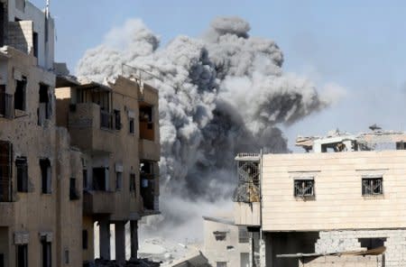 Smoke rises at the positions of the Islamic State militants after an air strike by the coalition forces near the stadium in Raqqa, Syria, October 4. REUTERS/Erik De Castro