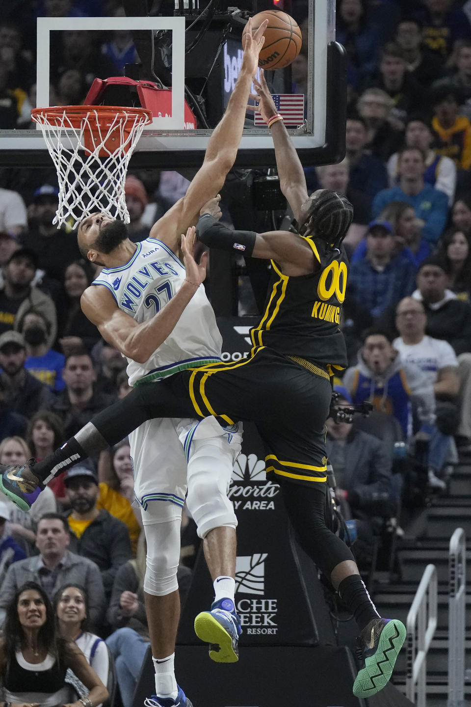 Minnesota Timberwolves center Rudy Gobert, left, defends against a shot by Golden State Warriors forward Jonathan Kuminga (00) during the first half of an NBA basketball game in San Francisco, Sunday, Nov. 12, 2023. (AP Photo/Jeff Chiu)