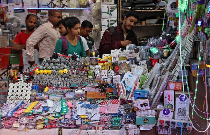 People buy electric goods at a roadside market in Kolkata