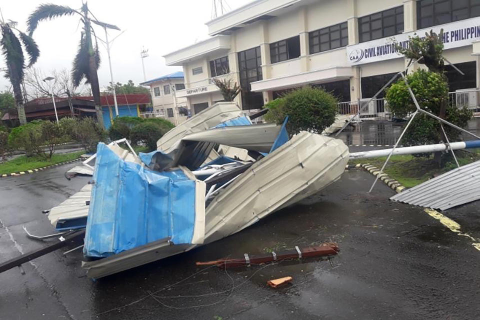 In this photo provided by the Civil Aviation Authority of the Philippines, debris from a damaged structure at the Naga airport in Naga city, central Philippines, as Typhoon Goni hits the country Sunday, Nov. 1, 2020. The super typhoon has slammed into the eastern Philippines with ferocious winds, knocking down power in several towns and prompting the evacuation of about a million people in its projected path. (Civil Aviation Authority of the Philippines via AP)