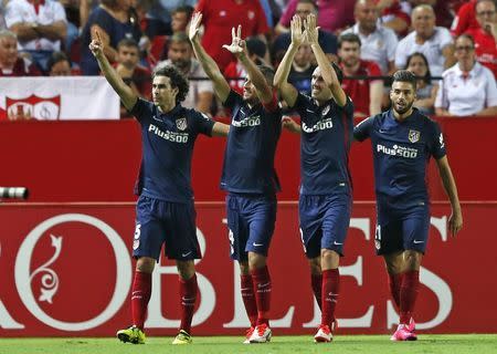 Atletico Madrid's Gabi (2nd L) celebrates with teammates after scoring against Sevilla during their Spanish first division soccer match at Ramon Sanchez Pizjuan stadium in Seville, southern Spain, August 30, 2015. REUTERS/Marcelo del Pozo