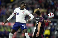 United States' Tim Weah, left, goes up for the ball against Mexico's Hector Herrera during the first half of a FIFA World Cup qualifying soccer match, Friday, Nov. 12, 2021, in Cincinnati. (AP Photo/Julio Cortez)