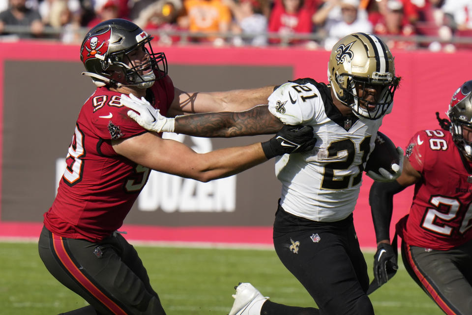 Tampa Bay Buccaneers linebacker Anthony Nelson (98) commits a hores collar penalty as he tackles New Orleans Saints running back Jamaal Williams (21) in the second half of an NFL football game in Tampa, Fla., Sunday, Dec. 31, 2023. (AP Photo/Chris O'Meara)