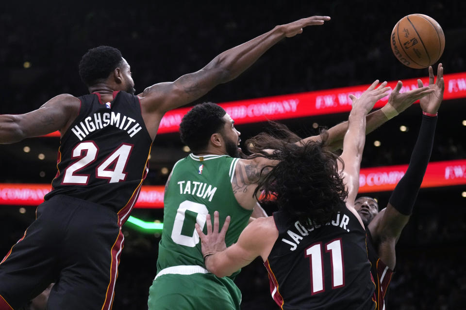 Boston Celtics forward Jayson Tatum (0) drives to the basket through the Miami Heat during the first half of Game 2 of an NBA basketball first-round playoff series, Wednesday, April 24, 2024, in Boston. (AP Photo/Charles Krupa)