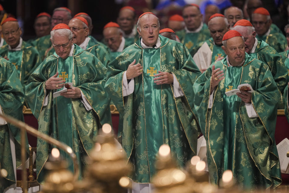 Newly-created Cardinal Robert Walter McElroy, center, Bishop of San Diego, CA, crosses himself at the beginning of a mass for the new cardinals celebrated by Pope Francis in St. Peter's Basilica at The Vatican Tuesday, Aug. 30, 2022, concluding a two-day consistory on the Praedicate Evangelium (Preach the Gospel) apostolic constitution reforming the Roman Curia which was promulgated in March. Francis created 20 new cardinals on Saturday. (AP Photo/Andrew Medichini)