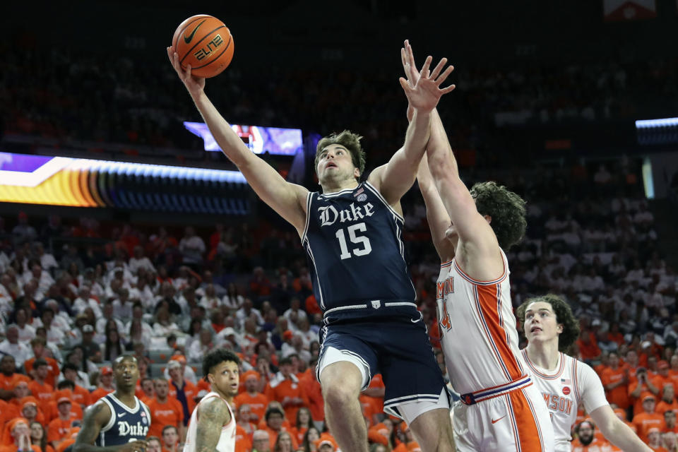 Duke center Ryan Young (15) scores over Clemson forward Ian Schieffelin (4) during the first half of an NCAA college basketball game in Clemson, S.C., Saturday, Jan. 14, 2023. (AP Photo/Artie Walker Jr.)