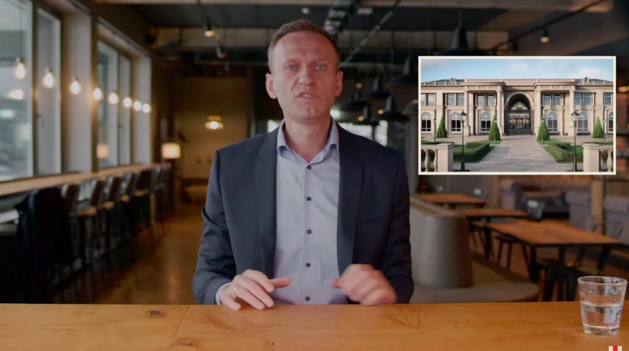 Alexei Navalny seen in a video alongside a rendering of what he says is Vladimir Putin's secret palace on the Black Sea.