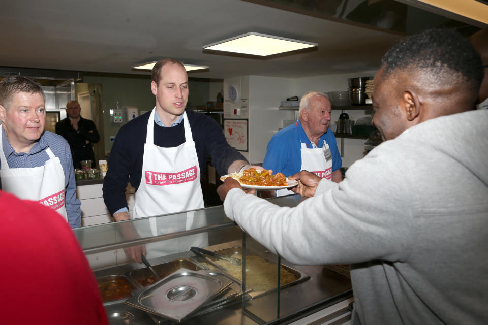 William helps to serve lunch at homeless charity The Passage [Photo: Getty]