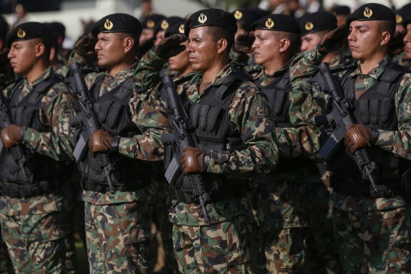 Members of Mexico's military salute during an official reception last week for U.S. Defense Secretary Chuck Hagel and Canadian Defense Minister Rob Nicholson in Mexico City. The Mexican military is believed to have long committed abuses with impunity.