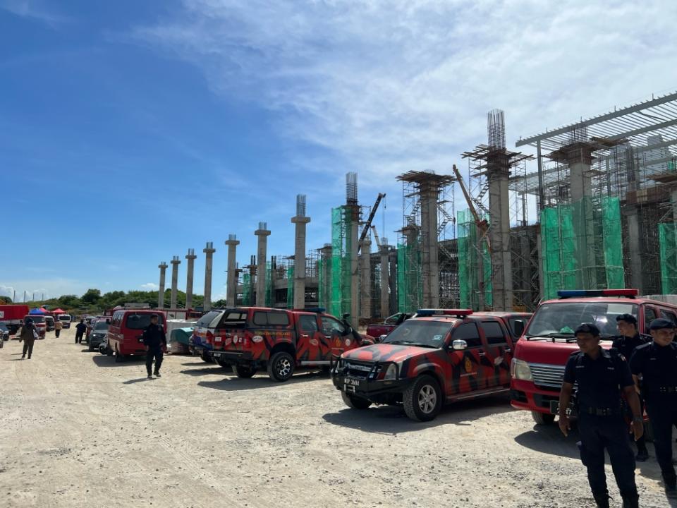 Fire and Rescue Department staff on site in Bayan Lepas to lend a hand in the search for four yet to be accounted for Bangladeshi workers believed to be trapped underneath tonnes of concrete rubble November 29, 2023 — Picture by Opalyn Mok