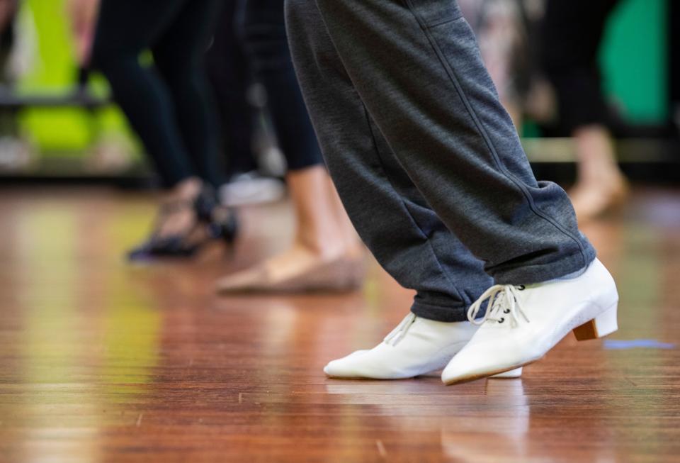 Individuals take a salsa dance class with Miriam Watkins, owner of Studio D, Sunday, April 18, 2021.