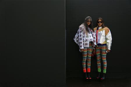 Fashion designers Nadia (R) and Zehra Mustafa pose outside Somerset House during London Fashion Week September 16, 2013. REUTERS/Stefan Wermuth