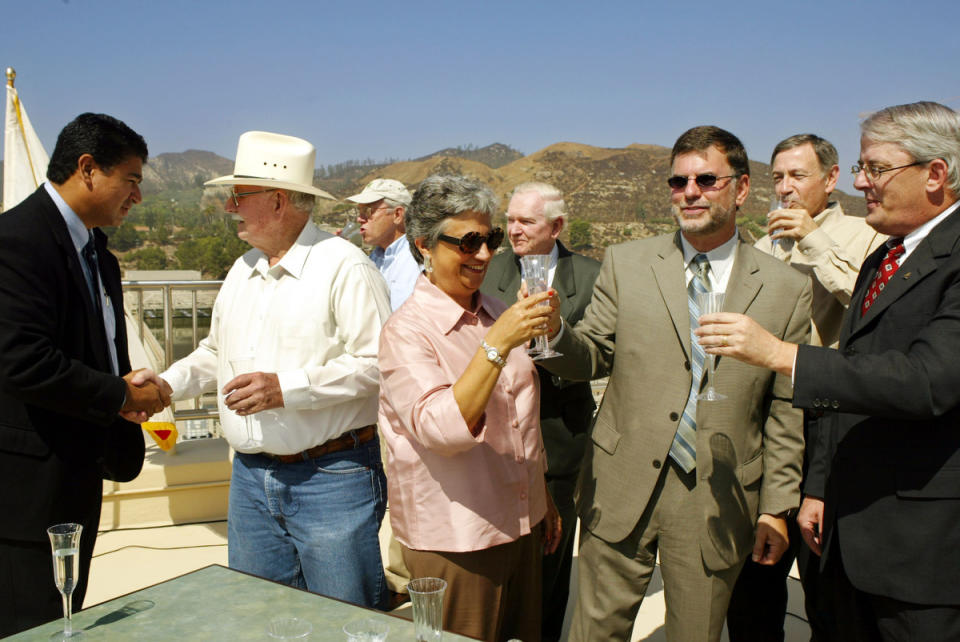 California Secretary for Resources Mary Nichols, center, toasts Richard Katz, senior advisor to Gov. Gray Davis, second from right, and Jack Foley, director of the Municipal Water District, right, along with other water and resources officials during a news conference announcing that Davis signed a package of bills on water sharing from the Colorado River, Sept. 29, 2003, at a water treatment plant in Los Angeles.