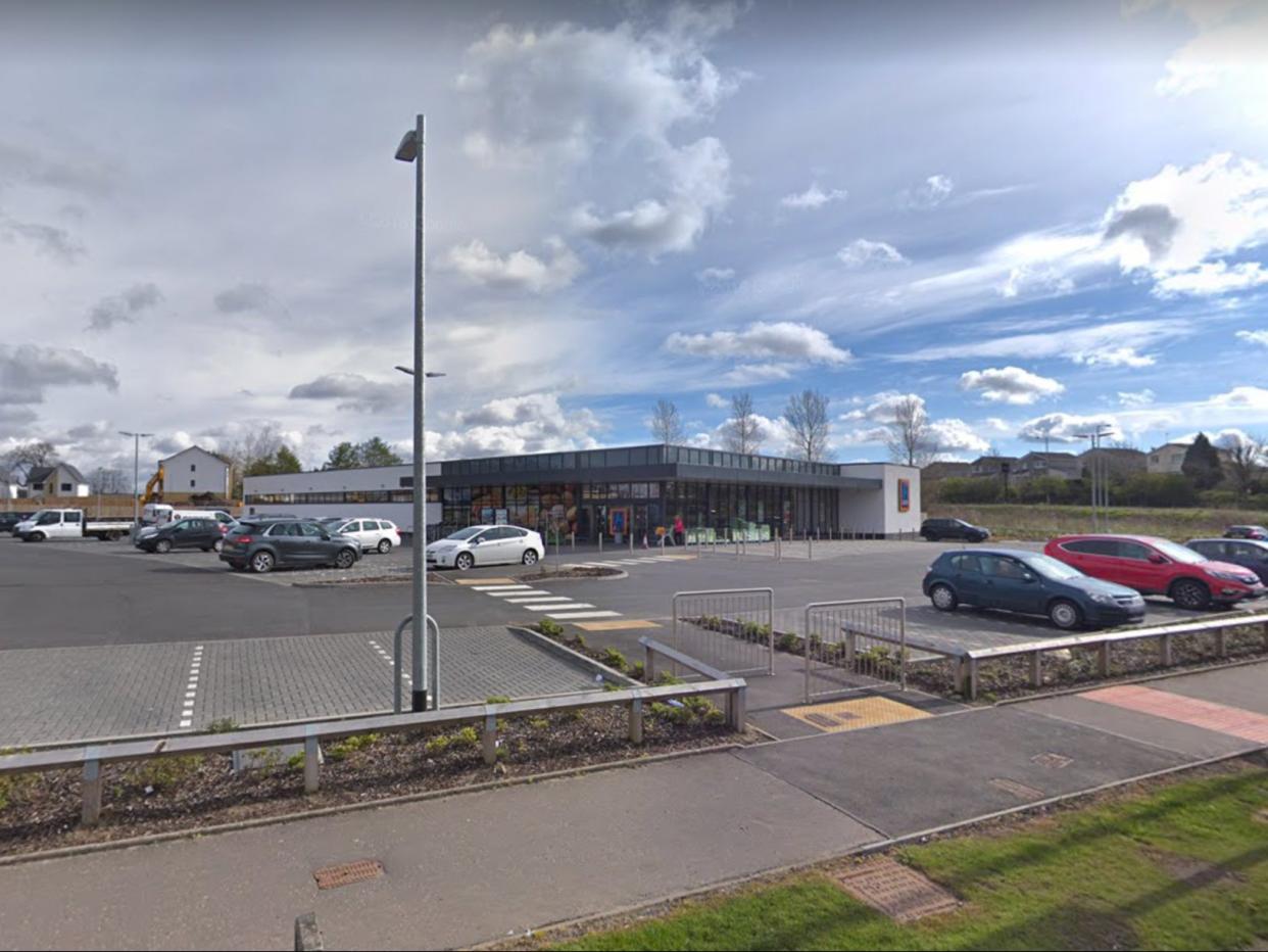 Police gathered outside the Newton Mearns branch of Aldi, seven miles southwest of Glasgow City Centre (Google Maps)